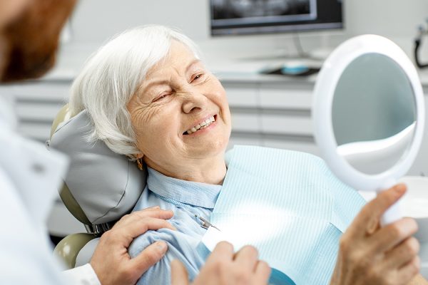 old lady just after dental implants